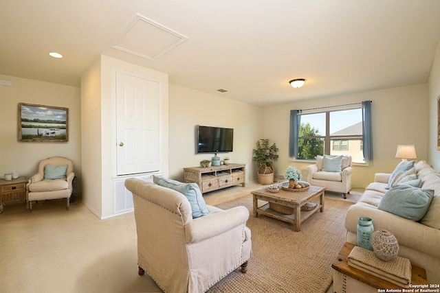 living area featuring attic access, baseboards, visible vents, recessed lighting, and light colored carpet
