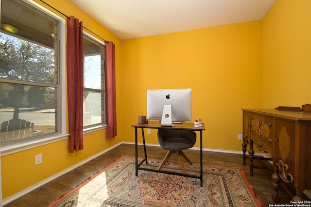 office space featuring baseboards, wood finished floors, and a healthy amount of sunlight