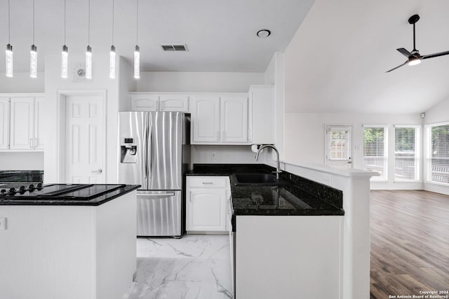 kitchen with a sink, a peninsula, ceiling fan, white cabinets, and stainless steel refrigerator with ice dispenser