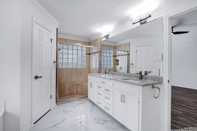 bathroom featuring double vanity, a shower stall, marble finish floor, and a sink