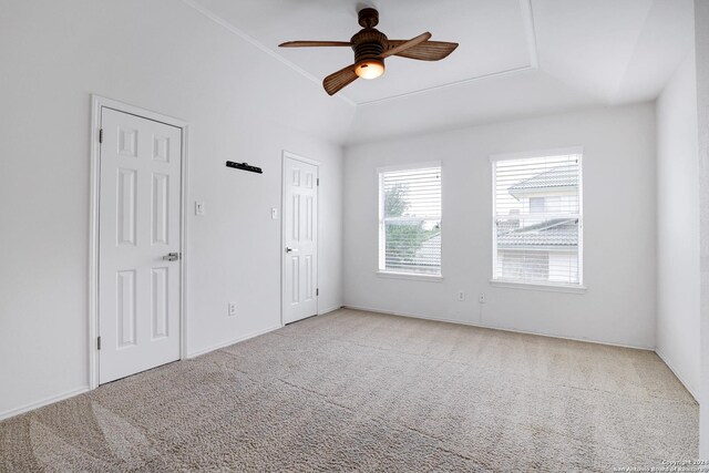 carpeted spare room with baseboards and ceiling fan