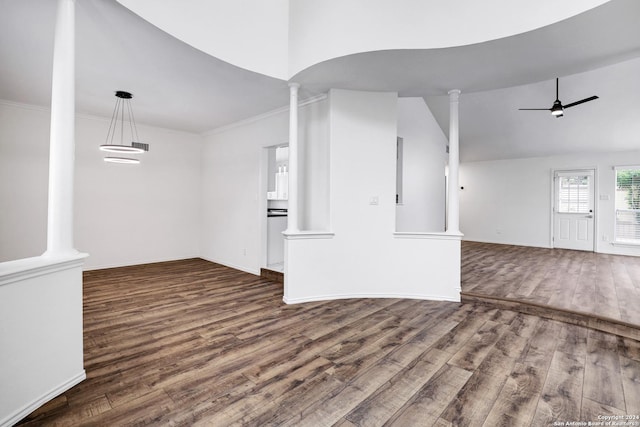 unfurnished living room with decorative columns, vaulted ceiling, wood finished floors, ceiling fan, and ornamental molding