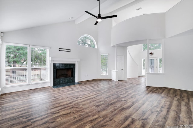 unfurnished living room with wood finished floors, visible vents, and high vaulted ceiling