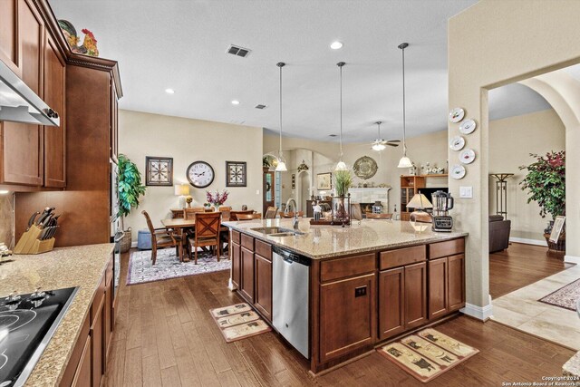534 Mission Hill Run, New Braunfels, TX 78132 - kitchen with a ceiling fan, stainless steel dishwasher, a sink, arched walkways, and black electric stovetop