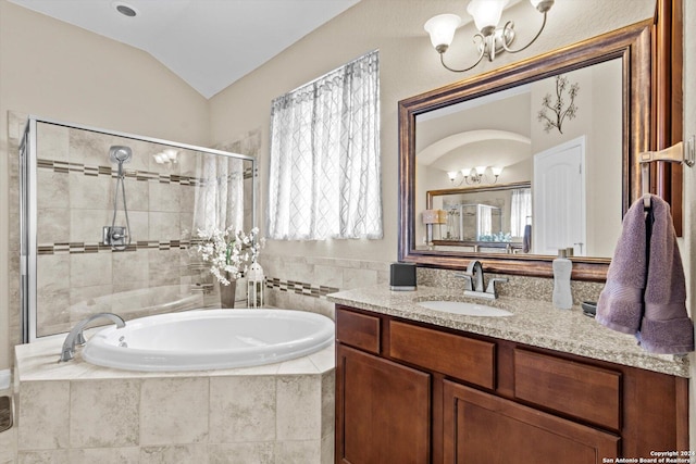 534 Mission Hill Run, New Braunfels, TX 78132 - bathroom featuring a shower stall, an inviting chandelier, vanity, a wealth of natural light, and a garden tub