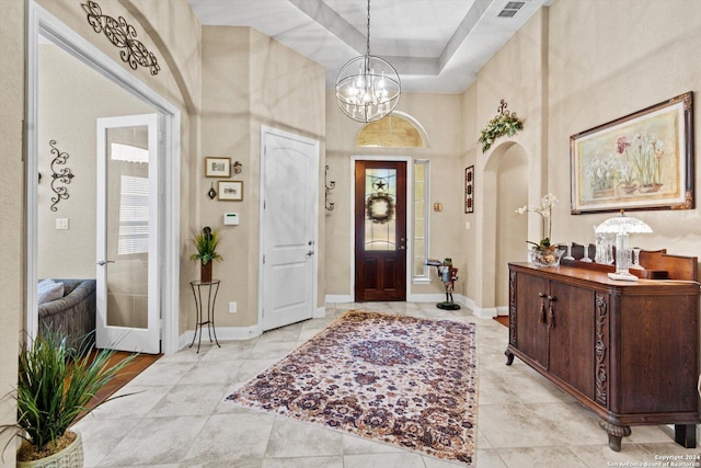 534 Mission Hill Run, New Braunfels, TX 78132 - entrance foyer featuring arched walkways, visible vents, baseboards, a notable chandelier, and a high ceiling