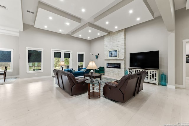 1191 Glenwood, Bulverde, TX 78163 - living area with beamed ceiling, a high ceiling, visible vents, a stone fireplace, and baseboards