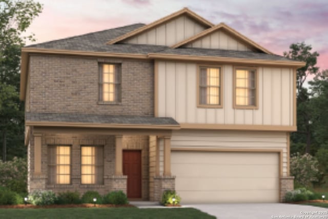view of front facade featuring board and batten siding, an attached garage, brick siding, and driveway