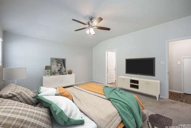 living area with carpet flooring, baseboards, vaulted ceiling, and ceiling fan