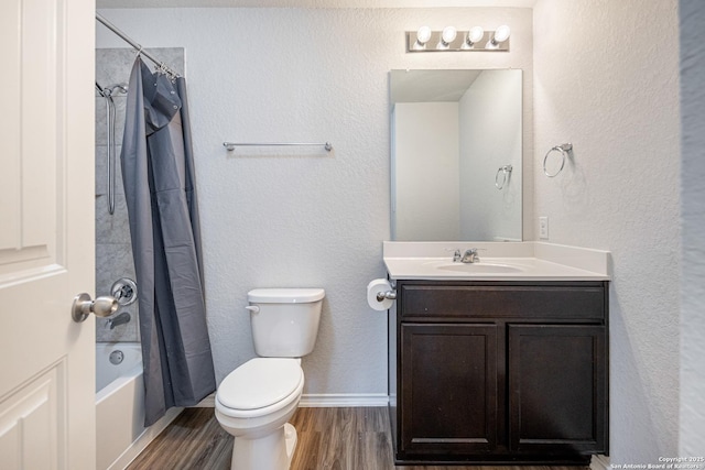 full bathroom featuring a textured wall, shower / bath combo, vanity, toilet, and wood finished floors