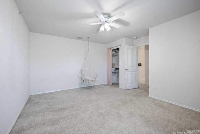 unfurnished bedroom featuring visible vents, carpet floors, a closet, baseboards, and a ceiling fan