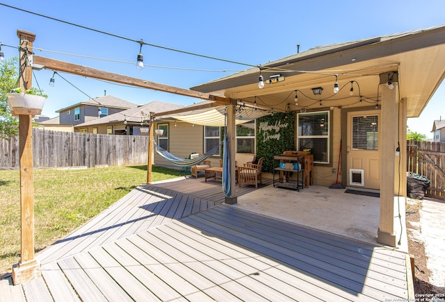 deck with a lawn and a fenced backyard