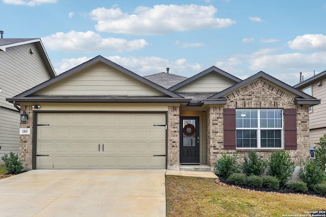 single story home with brick siding, an attached garage, and driveway