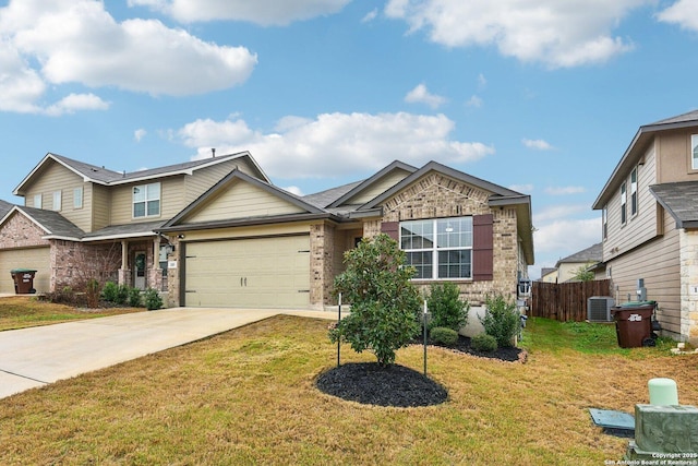 craftsman inspired home with a garage, a front yard, concrete driveway, and fence