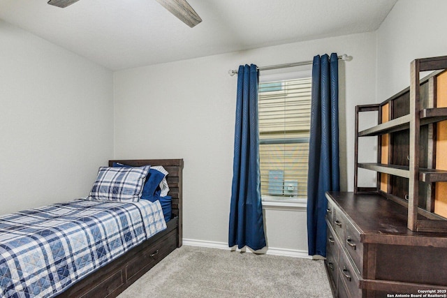 carpeted bedroom featuring a ceiling fan and baseboards
