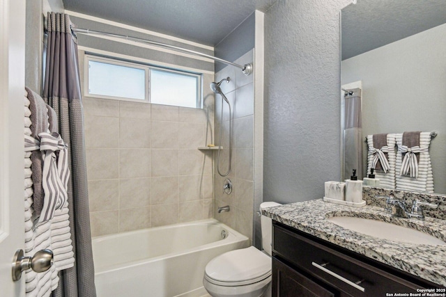 bathroom featuring toilet, a textured wall, vanity, and shower / tub combo with curtain