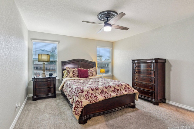 carpeted bedroom featuring baseboards, a textured wall, and a textured ceiling