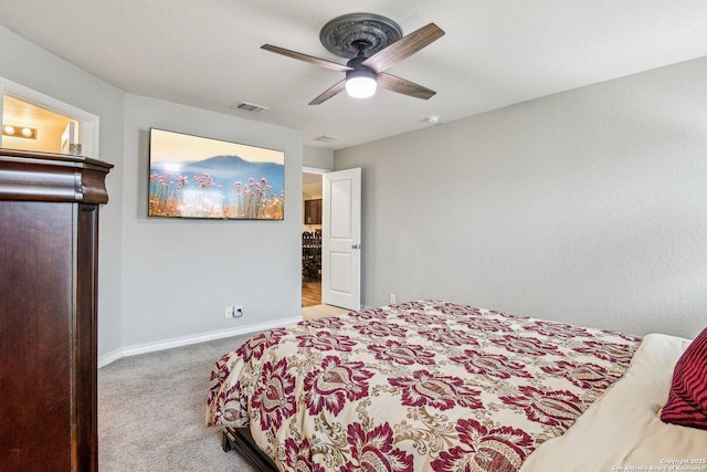 carpeted bedroom featuring visible vents, baseboards, and ceiling fan