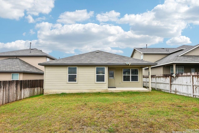 back of house featuring a fenced backyard, a yard, and a patio