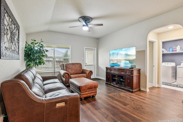 living area featuring independent washer and dryer, wood finished floors, a ceiling fan, and vaulted ceiling
