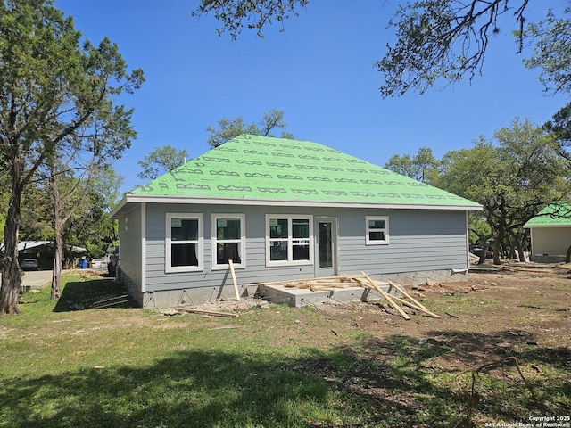rear view of house featuring a yard