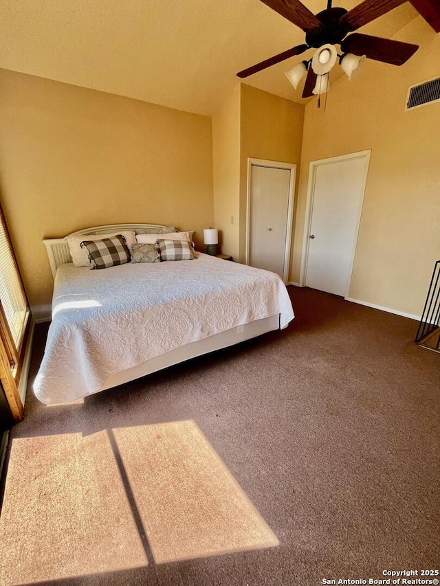 carpeted bedroom with baseboards, visible vents, and ceiling fan