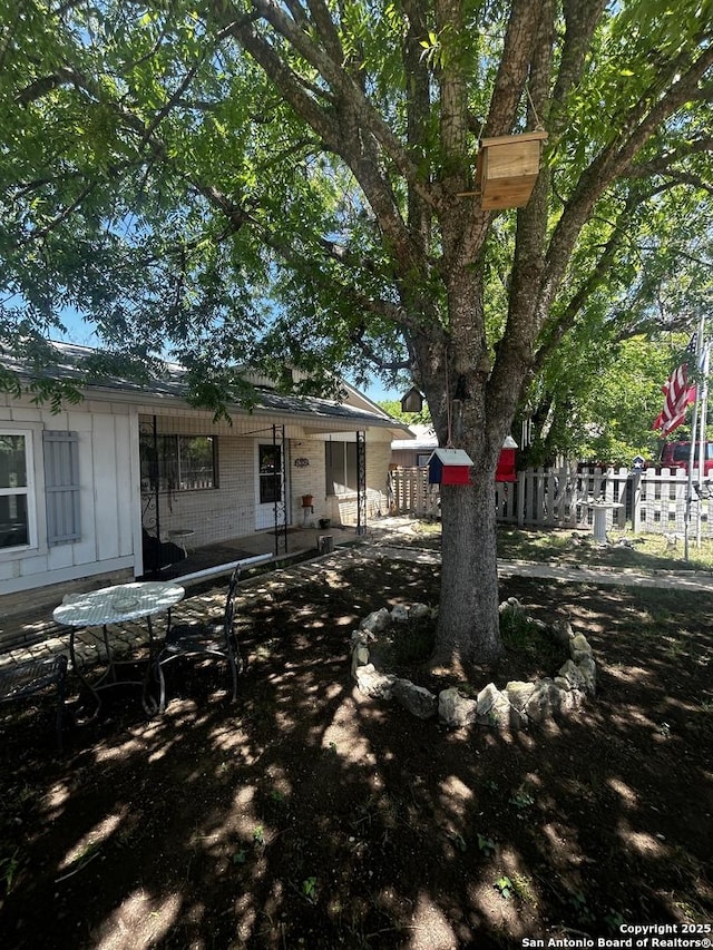 view of yard featuring a patio and fence
