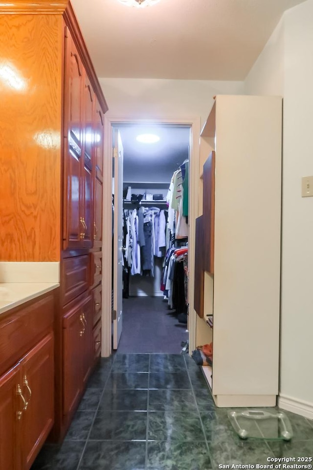 hallway featuring dark tile patterned flooring