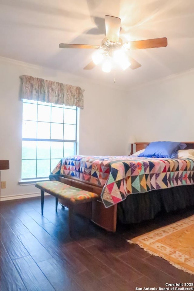 bedroom with wood finished floors, ceiling fan, and ornamental molding