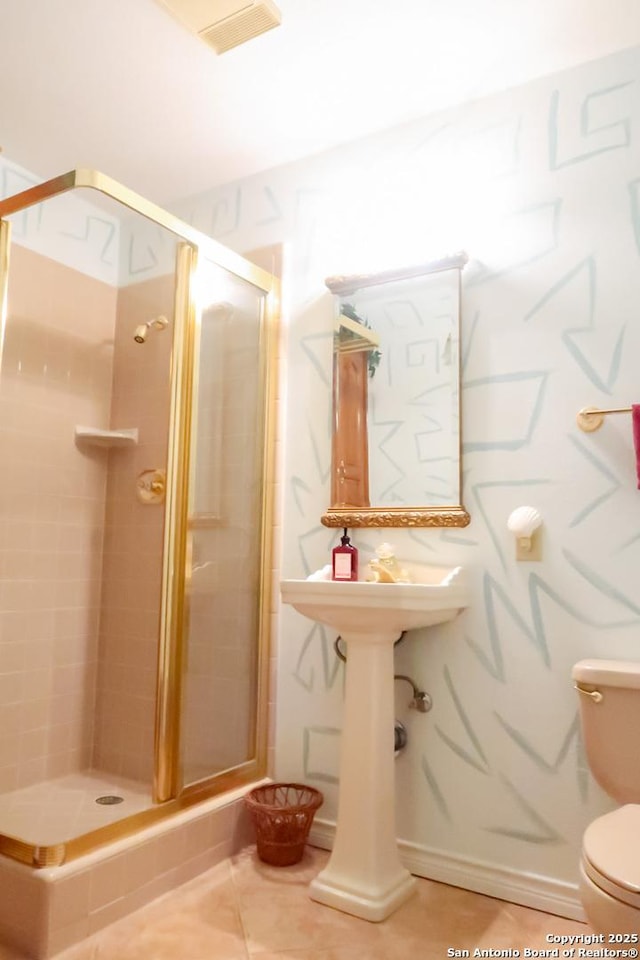 bathroom with a shower stall, toilet, tile patterned flooring, and visible vents