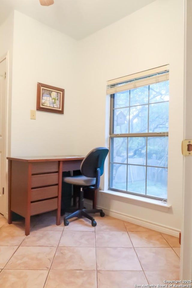 home office with baseboards and light tile patterned floors