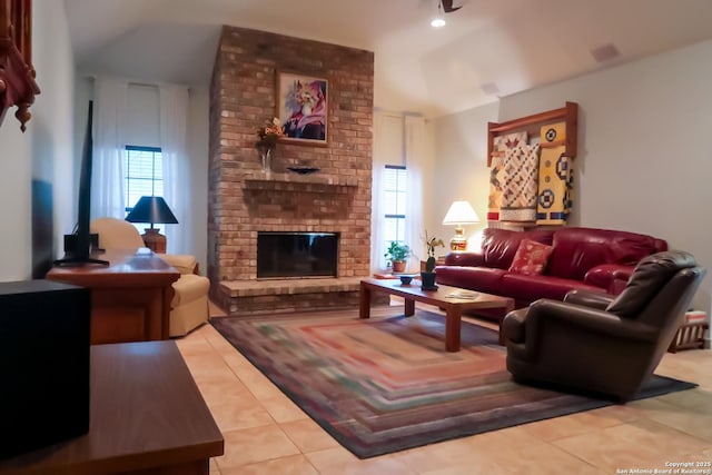 tiled living area with a fireplace and lofted ceiling
