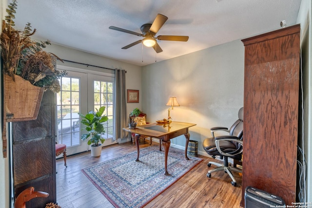 office space with baseboards, a ceiling fan, french doors, and wood finished floors
