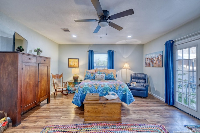 bedroom featuring wood finished floors, visible vents, and recessed lighting