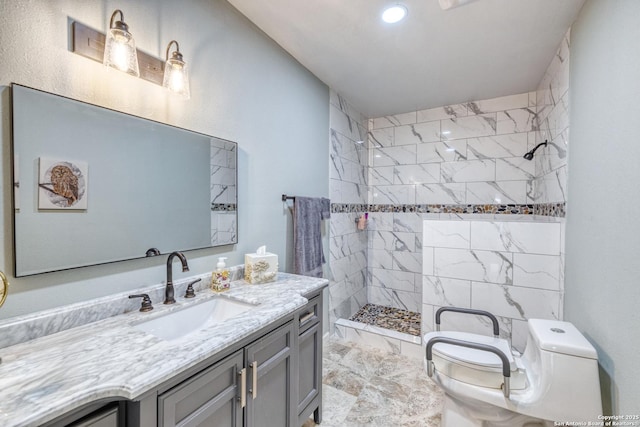 full bathroom with tiled shower, toilet, recessed lighting, marble finish floor, and vanity