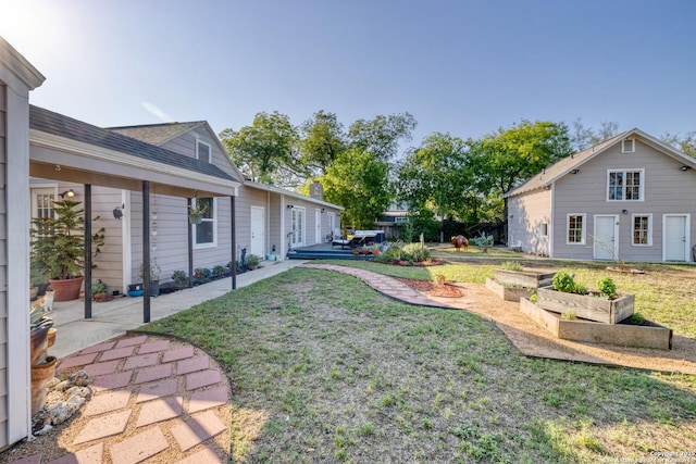 view of yard featuring a garden and a patio