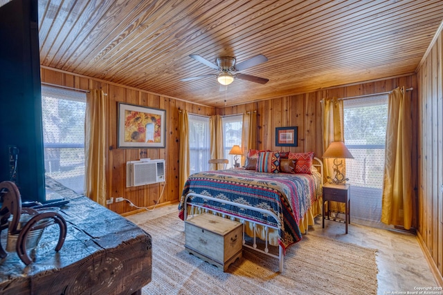 bedroom featuring wooden ceiling, wood walls, a wall unit AC, and a ceiling fan