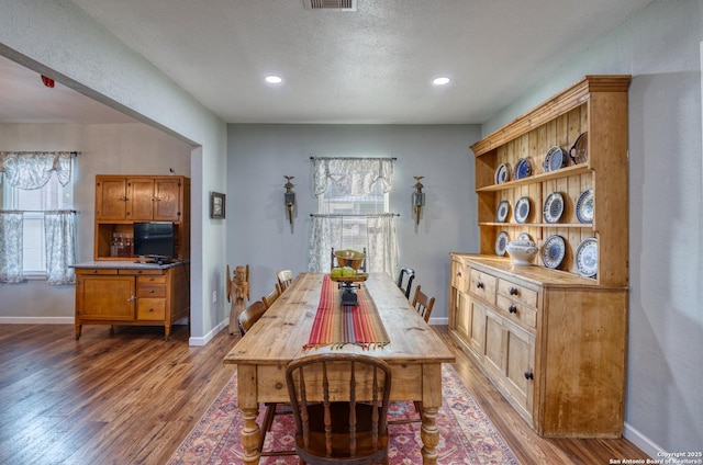 dining area with a healthy amount of sunlight, light wood finished floors, and baseboards