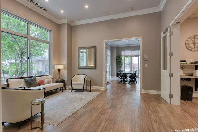 sitting room featuring crown molding, recessed lighting, light wood-style flooring, and baseboards