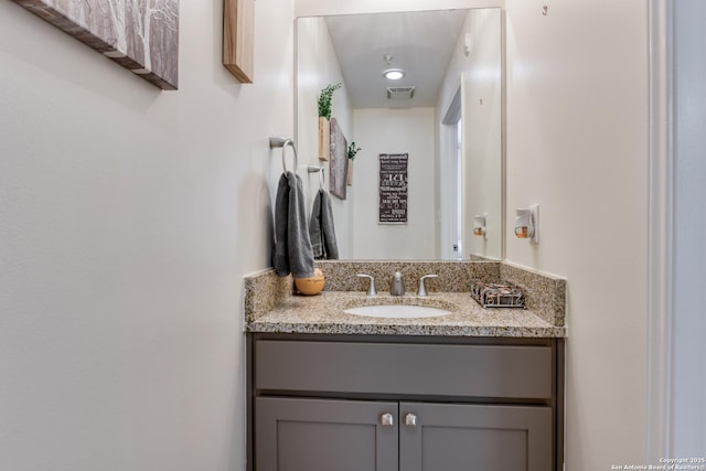 bathroom with visible vents and vanity