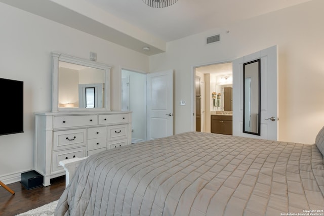 bedroom featuring ensuite bathroom, visible vents, baseboards, and dark wood-type flooring