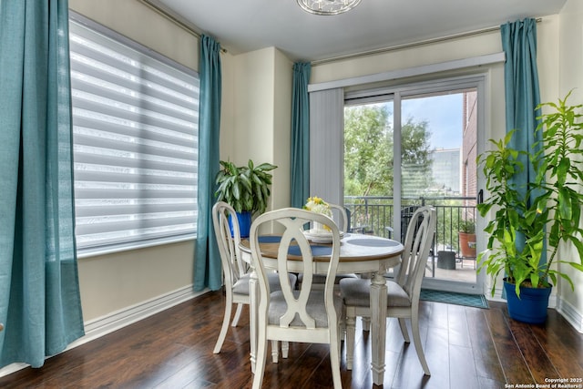 dining space featuring hardwood / wood-style floors and baseboards