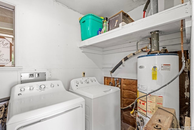 laundry room featuring gas water heater, washing machine and clothes dryer, and laundry area