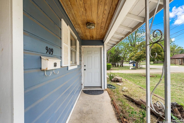 property entrance featuring a lawn