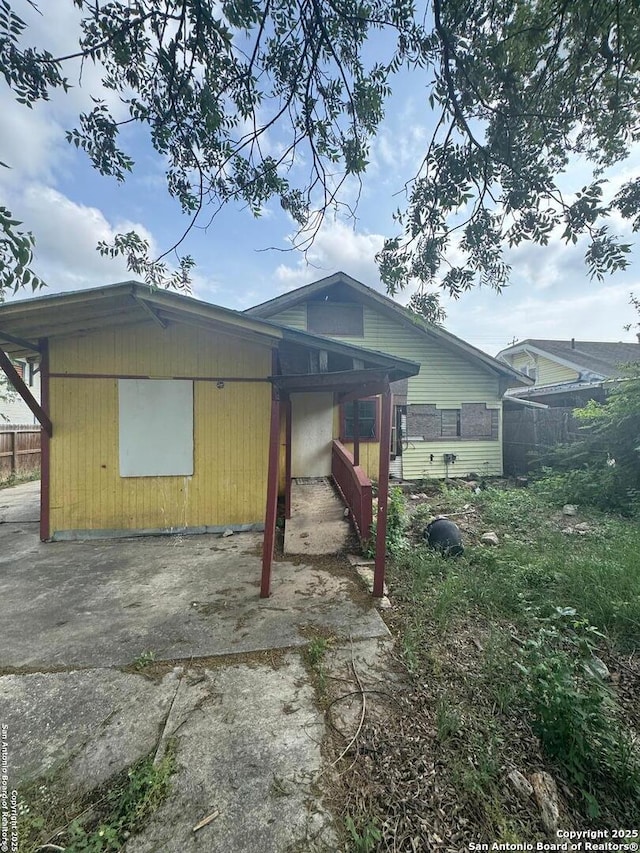 back of house featuring fence and a patio area