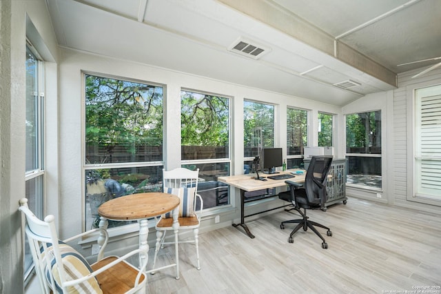 sunroom featuring visible vents, lofted ceiling with beams, wood finished floors, and a wooden deck