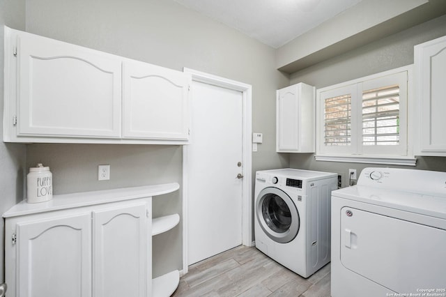 laundry room with separate washer and dryer, cabinet space, and light wood-style floors