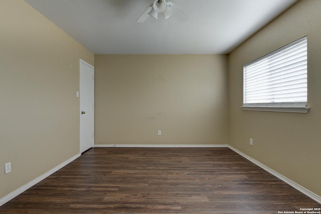 empty room with dark wood-style flooring, ceiling fan, and baseboards