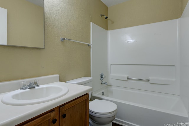 bathroom featuring toilet, vanity, and tub / shower combination