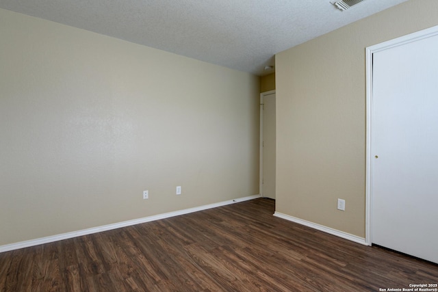 unfurnished bedroom with dark wood-type flooring and baseboards